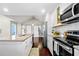 Modern kitchen featuring granite countertops, stainless steel appliances, and white cabinets, creating a sleek and functional design at 1947 Maywood Nw Pl, Atlanta, GA 30318