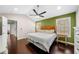 Main bedroom features hardwood floors, a ceiling fan, and natural light at 1947 Maywood Nw Pl, Atlanta, GA 30318