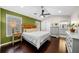 Main bedroom features hardwood floors, a ceiling fan, ensuite bath and natural light at 1947 Maywood Nw Pl, Atlanta, GA 30318