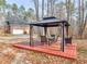 Relaxing backyard setup with a gazebo on a wooden deck and natural surroundings at 355 Parker Rd, Covington, GA 30014