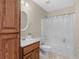 Bright bathroom features a shower and tub combination with a wooden vanity at 355 Parker Rd, Covington, GA 30014