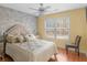 Serene bedroom with brick accent wall, decorative ceiling fan, and a large window bathing the room in natural light at 355 Parker Rd, Covington, GA 30014