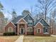 Beautiful two-story home featuring a brick facade, a welcoming front porch and mature trees in a tranquil landscape at 355 Parker Rd, Covington, GA 30014