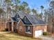 Side view of a beautiful brick home with a prominent side garage, mature trees, and well-maintained surroundings at 355 Parker Rd, Covington, GA 30014