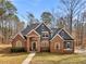 Charming brick home with gabled roof, manicured lawn, and inviting entrance exuding curb appeal and timeless elegance at 355 Parker Rd, Covington, GA 30014