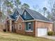 A stunning brick home featuring a side-entry garage, well-kept lawn, and stately design, blends charm with practicality at 355 Parker Rd, Covington, GA 30014
