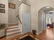 The foyer features hardwood floors, staircase, and an arched doorway leading to a sunny living space at 355 Parker Rd, Covington, GA 30014
