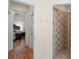 Hallway leading to a bedroom and bathroom featuring hardwood floors and white trim at 355 Parker Rd, Covington, GA 30014