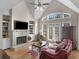 Bright living room with vaulted ceilings, fireplace, and built-in bookshelves at 355 Parker Rd, Covington, GA 30014