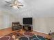 Cozy living room with ceiling fan, TV, recliner, and hardwood flooring at 355 Parker Rd, Covington, GA 30014