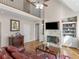 Inviting living room with a fireplace, built-in shelving, and a staircase leading to the second floor at 355 Parker Rd, Covington, GA 30014