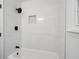 Bright bathroom features white subway tile, black fixtures, and a tub-shower combination at 3569 Vinyard Way, Lawrenceville, GA 30044