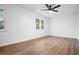 Bright, freshly painted bedroom featuring modern ceiling fan and wood-look laminate flooring at 3569 Vinyard Way, Lawrenceville, GA 30044