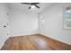 Clean bedroom featuring laminate flooring, a ceiling fan, and a double window with outside views at 3569 Vinyard Way, Lawrenceville, GA 30044