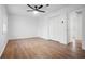 Spacious bedroom featuring a ceiling fan, laminate flooring, and ample closet space for storage at 3569 Vinyard Way, Lawrenceville, GA 30044