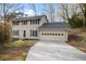 Charming two-story home with tan siding, dark shutters, and an attached two-car garage at 3569 Vinyard Way, Lawrenceville, GA 30044