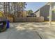Backyard view featuring a concrete patio area, wood fence for privacy, and some trees in the background at 405 Rabbits Run, Fayetteville, GA 30214