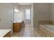 Bathroom with bathtub, window and sink at 405 Rabbits Run, Fayetteville, GA 30214