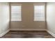Bedroom showing two windows and wood floors, neutral wall paint at 405 Rabbits Run, Fayetteville, GA 30214