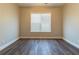 Bedroom with hardwood floors, neutral paint, and a large window at 405 Rabbits Run, Fayetteville, GA 30214