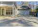 Wide driveway with detached garage and covered patio for outdoor relaxation and entertainment at 405 Rabbits Run, Fayetteville, GA 30214
