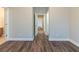Hallway with hardwood floors and neutral paint offers seamless transitions at 405 Rabbits Run, Fayetteville, GA 30214