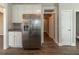 Well appointed kitchen featuring stainless steel refrigerator, granite counters and hardwood floors at 405 Rabbits Run, Fayetteville, GA 30214