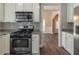 Open kitchen with stainless steel appliances, granite countertops and view into dining area at 405 Rabbits Run, Fayetteville, GA 30214
