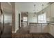 Open concept kitchen features granite countertops, stainless steel appliances, and white cabinets at 405 Rabbits Run, Fayetteville, GA 30214