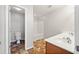 Bright bathroom with double sinks, updated fixtures, tub, and a separate toilet area at 540 Ridge View Xing, Woodstock, GA 30188