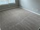 Neutral carpeted bedroom with window offering natural light; perfect for relaxation at 540 Ridge View Xing, Woodstock, GA 30188