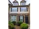 Two story townhome with brick and siding, black shutters, and a well-maintained front yard at 540 Ridge View Xing, Woodstock, GA 30188