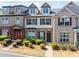 Charming townhome featuring a brick facade, dormer windows and well-maintained landscaping at 540 Ridge View Xing, Woodstock, GA 30188