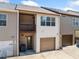 Two-story townhouse exterior with a balcony, tan siding, and one-car garage at 540 Ridge View Xing, Woodstock, GA 30188