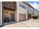 Two-story townhouse exterior with a balcony, tan siding, and one-car garage at 540 Ridge View Xing, Woodstock, GA 30188
