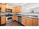 Spacious kitchen with stainless steel appliances, wood cabinets, and a convenient layout at 540 Ridge View Xing, Woodstock, GA 30188