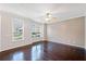 Well-lit living room with hardwood floors, large windows, and ceiling fan at 540 Ridge View Xing, Woodstock, GA 30188