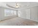 Spacious main bedroom with tray ceiling, ceiling fan and natural light at 540 Ridge View Xing, Woodstock, GA 30188