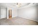 Generous main bedroom with a large closet entrance, neutral carpet and modern fan at 540 Ridge View Xing, Woodstock, GA 30188