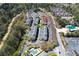 Aerial view showing the layout of the townhome community, adjacent woods, pool, and nearby shopping center at 7104 Woodland Ln, Alpharetta, GA 30009