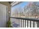 The balcony has white railings and a leafy plant with a view of trees and the street below at 7104 Woodland Ln, Alpharetta, GA 30009