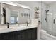 Spa-like bathroom with dual sinks, elegant vanity, and a glass-enclosed shower at 7104 Woodland Ln, Alpharetta, GA 30009
