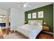 Bright bedroom features an accent wall and views into the bathroom and kitchen at 7104 Woodland Ln, Alpharetta, GA 30009