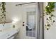 Hallway showcasing a glass door, white desk, decorative plants, and soft lighting at 7104 Woodland Ln, Alpharetta, GA 30009