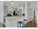 Eat-in kitchen with stainless steel appliances, stone countertops and island with barstool seating at 7104 Woodland Ln, Alpharetta, GA 30009