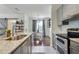 Kitchen and dining area with stainless steel appliances, stone countertops and stylish fixtures at 7104 Woodland Ln, Alpharetta, GA 30009