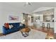 Bright, open-concept living room featuring hardwood floors, modern furniture, and a barn door leading to other spaces at 7104 Woodland Ln, Alpharetta, GA 30009