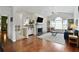 Spacious living room featuring a fireplace, hardwood floors, large window, and a cozy seating area at 7104 Woodland Ln, Alpharetta, GA 30009