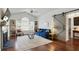 Well-lit living room featuring a fireplace, hardwood floors, modern furniture, and a stylish barn door at 7104 Woodland Ln, Alpharetta, GA 30009