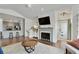Inviting living area showcasing a fireplace, hardwood floors, and seamless transition to the modern kitchen at 7104 Woodland Ln, Alpharetta, GA 30009